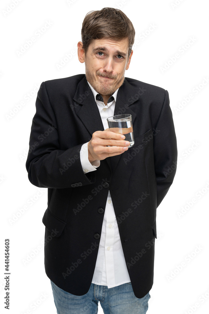 Young handsome tall slim white man with brown hair with glass full of water in black blazer isolated on white background Young handsome tall slim white man with brown hair with glass full of water in black blazer isolated on white background