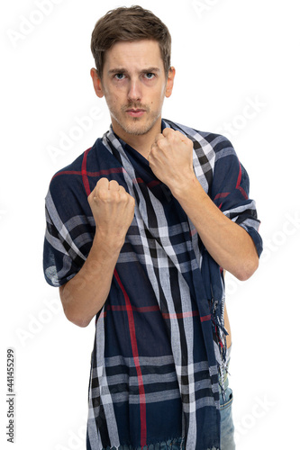 Young handsome tall slim white man with brown hair is ready to fight with scarf over his body isolated on white background