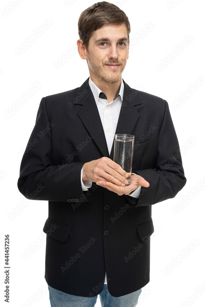 Young handsome tall slim white man with brown hair with glass of water in black blazer isolated on white background Young handsome tall slim white man with brown hair with glass of water in black blazer isolated on white background