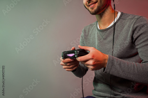 Man holding joystick and play virtual game © oksix