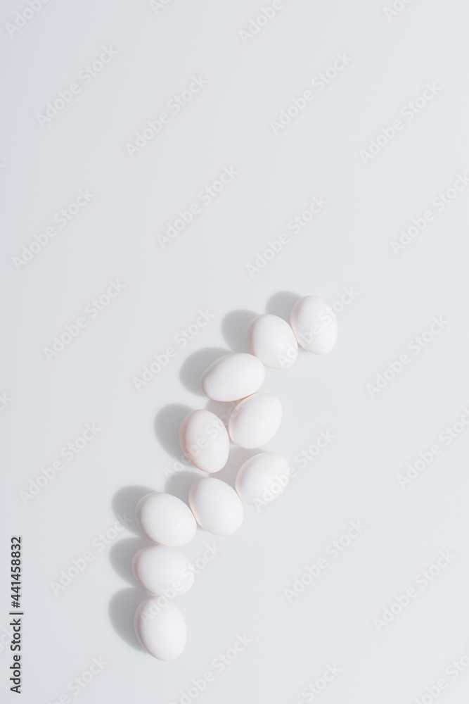 top view of raw and organic eggs in shell on white background top view of raw and organic eggs in shell on white background