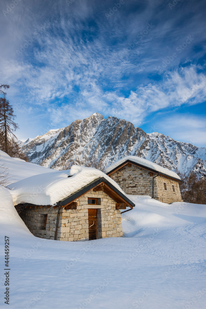 Mountain hut in the snow at sunset, Adamello Park, Edolo, Lombardy, Italy Mountain hut in the snow at sunset, Adamello Park, Edolo, Lombardy, Italy