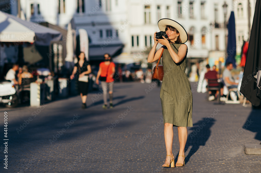 Woman with camera walking in the city