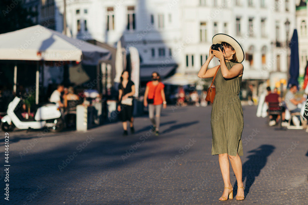 Woman with camera walking in the city