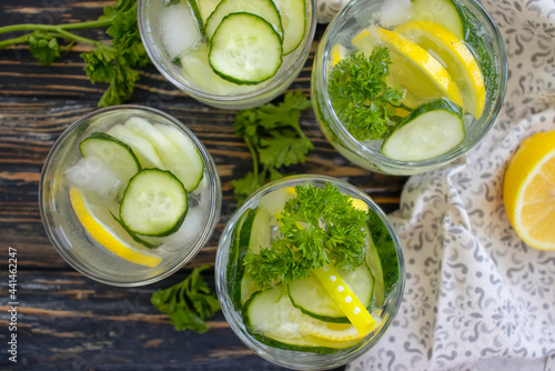 glass of water, lemon, cucumber, parsley 