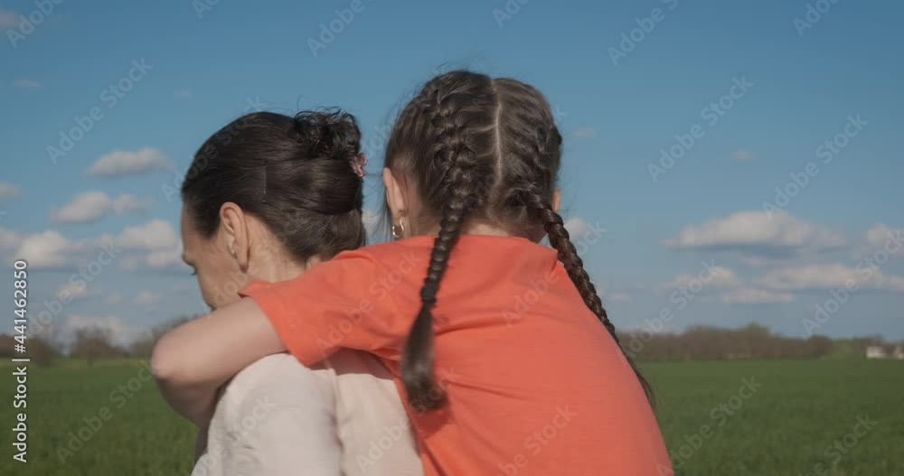 Woman with child in the wheat field. A mother and her nice little girl pass their holiday together in the green wheat. Woman with child in the wheat field. A mother and her nice little girl pass their holiday together in the green wheat.