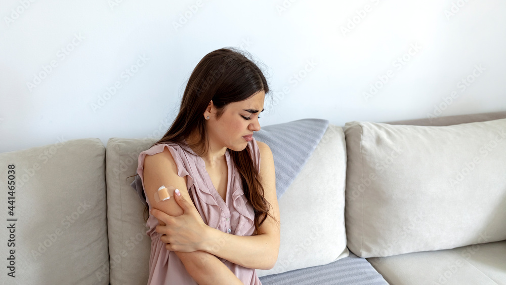 Pretty young woman has a painful condition after receiving the vaccine. Attractive Caucasian woman receive COVID-19 anti virus vaccine in campaign vaccination safe life got side effect pain at arm. Pretty young woman has a painful condition after receiving the vaccine. Attractive Caucasian woman receive COVID-19 anti virus vaccine in campaign vaccination safe life got side effect pain at arm.