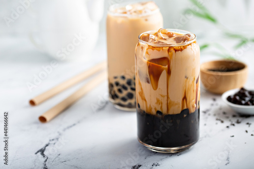 Boba milk tea in a tall glass with ice photo