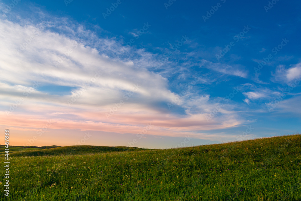 Sunset and blue sky with field.
