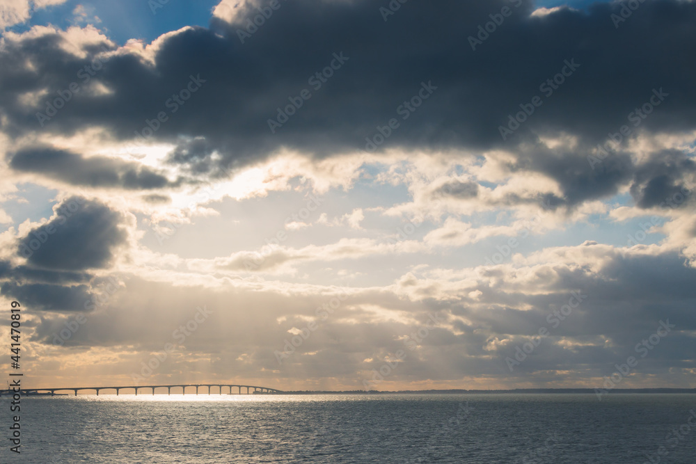 Bridge of Ré island and sunset over the sea