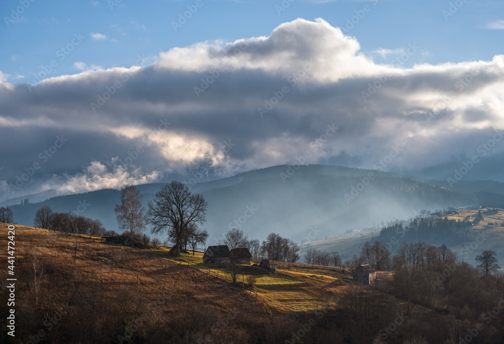 Picturesque morning above late autumn mountain countryside.  Ukraine, Carpathian Mountains. Peaceful traveling, seasonal, nature and countryside beauty concept scene.