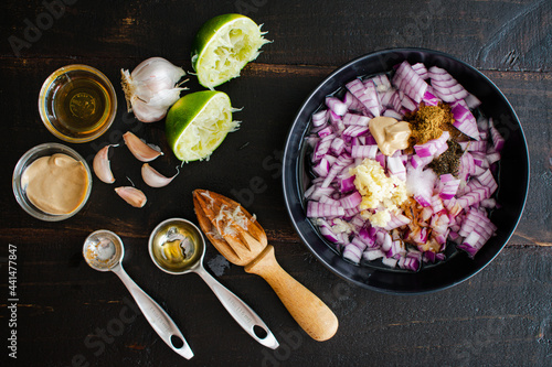 Prepping Ingredients for Steak Marinade: Diced onion, minced garlic, and other marinade ingredients on a small bowl