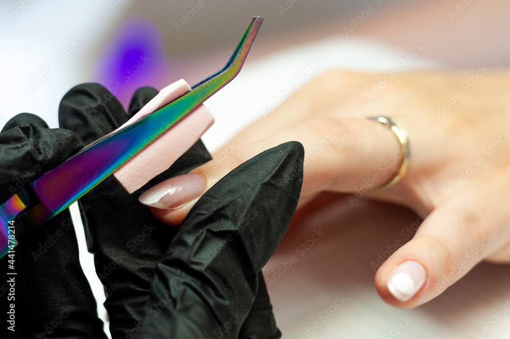 Nail stylist doing a manicure