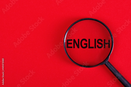 Magnifying glass with the inscription ENGLISH on a red background.