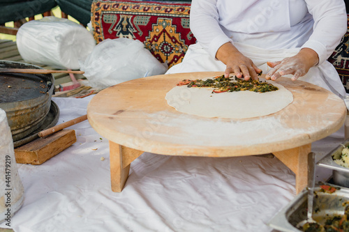 A woman prepares Turkish gözleme cakes in a hotel restaurant in Turkey