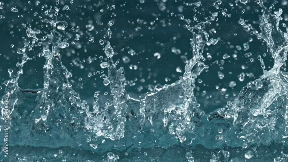 Super slow motion of splashing water isolated on blue background. Filmed on high speed cinema camera, 1000 fps. Super slow motion of splashing water isolated on blue background. Filmed on high speed cinema camera, 1000 fps.