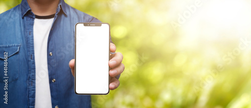 Man holding cell phone in hand with beautiful sunny day - easy modification photo