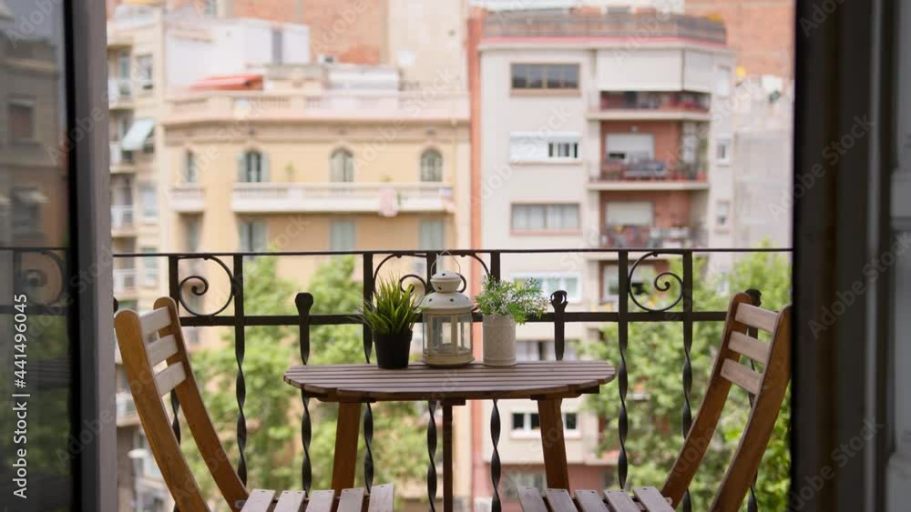 Empty beautiful exterior balcony table with no people Mediterranean city background during sunny summer day wide shot Empty beautiful exterior balcony table with no people Mediterranean city background during sunny summer day wide shot