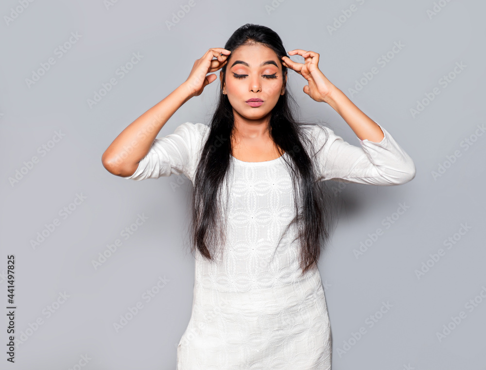 Asian Young beautiful woman has a headache, touching her head with eyes closed Exhausted girl portrait isolated over gray background Asian Young beautiful woman has a headache, touching her head with eyes closed Exhausted girl portrait isolated over gray background