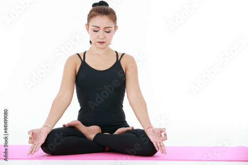 Asian woman meditating in Lotus pose