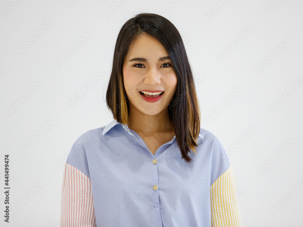 Image of happy young Asian woman posing isolated over grey wall background with friendly positive face Image of happy young Asian woman posing isolated over grey wall background with friendly positive face