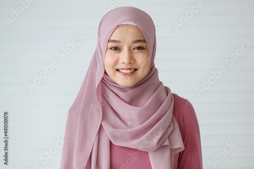 Portrait of a beautiful Muslim woman with a friendly and warm smile posing to the camera with self-confidence