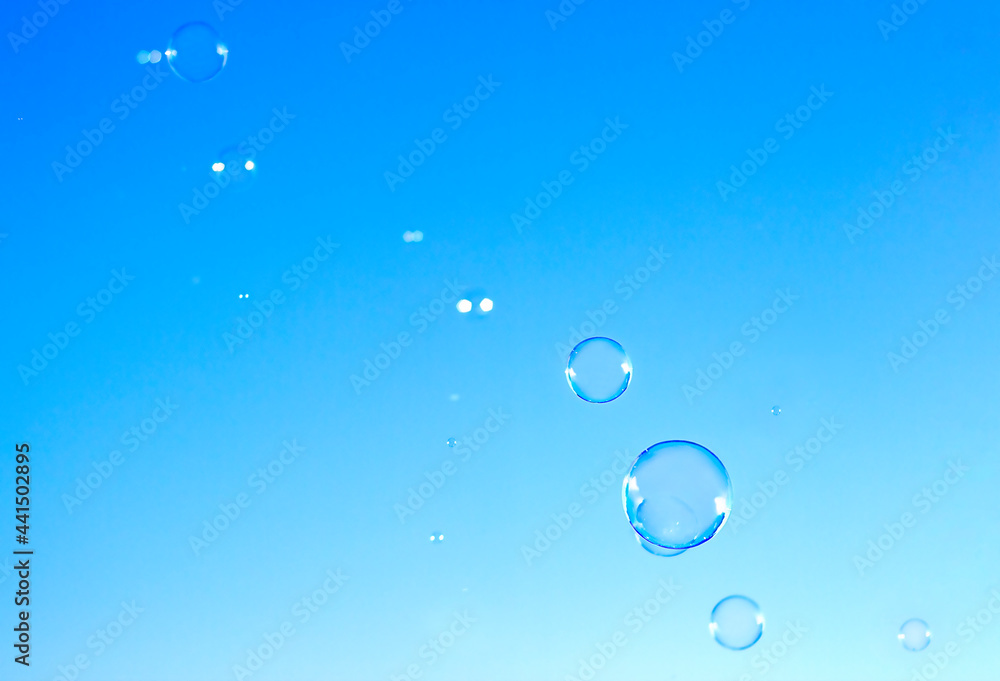 soap bubbles fly against the blue sky