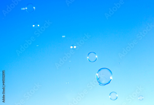 soap bubbles fly against the blue sky