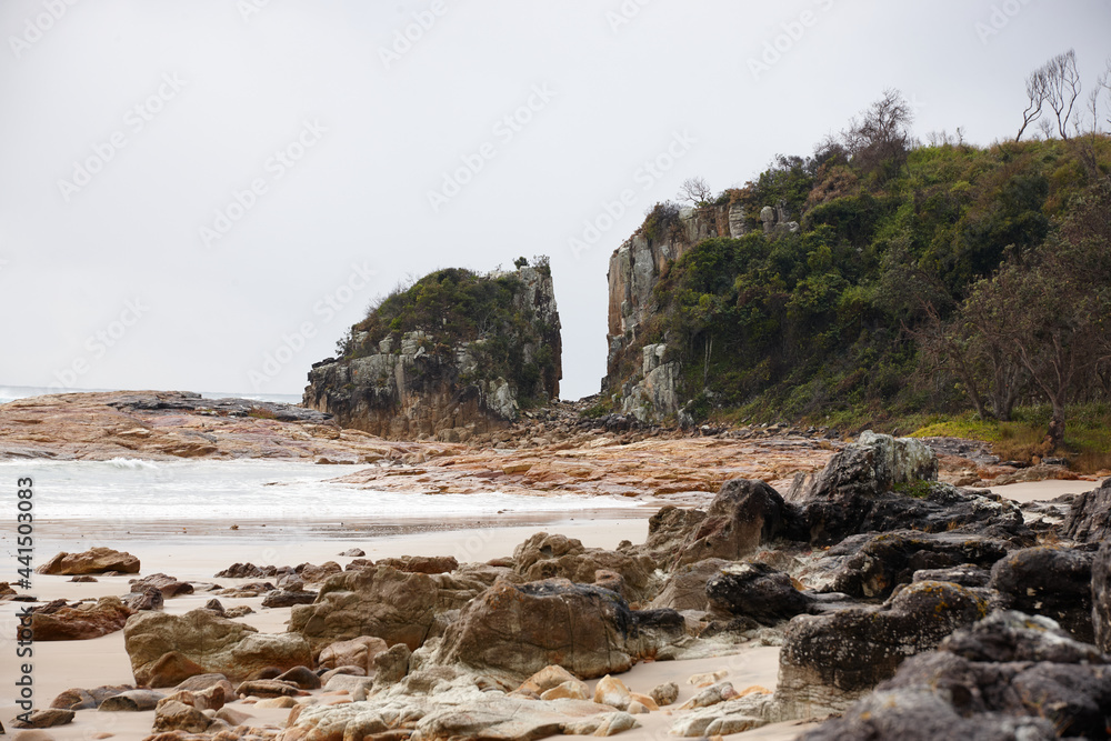 Gap in coastal rocky headland landscape on overcast day Gap in coastal rocky headland landscape on overcast day