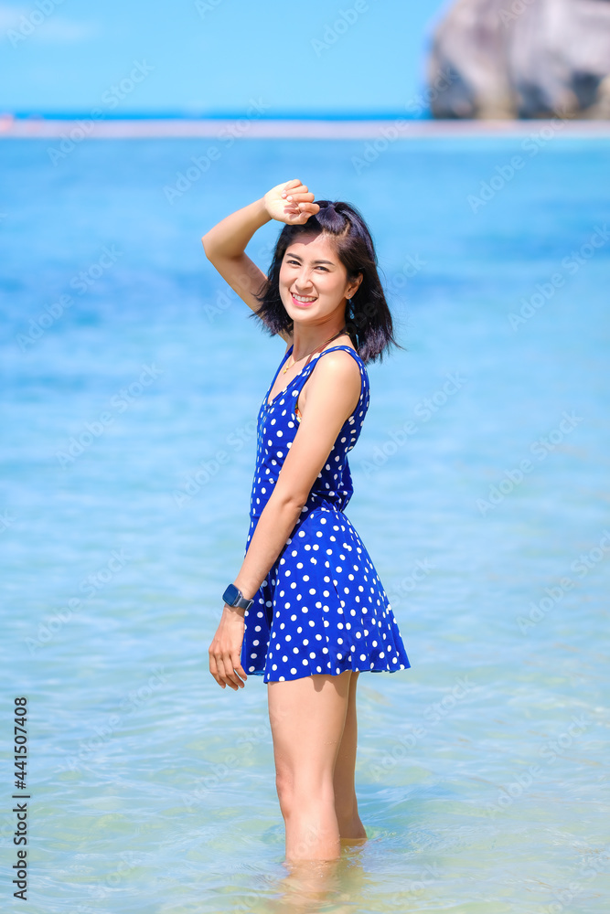 woman in blue dress on the beach, at leela beach koh phangan ,suratthani,thailand woman in blue dress on the beach, at leela beach koh phangan ,suratthani,thailand