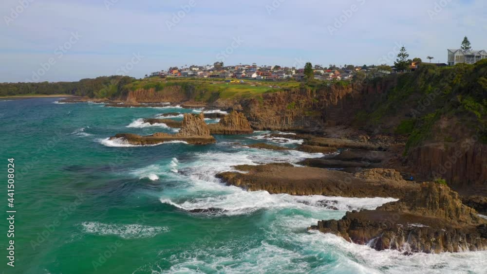 Scenic View Of Sea Stacks At Cathedral Rocks Near Coastal Town In Kiama Downs, New South Wales, Australia - aerial drone shot Scenic View Of Sea Stacks At Cathedral Rocks Near Coastal Town In Kiama Downs, New South Wales, Australia - aerial drone shot