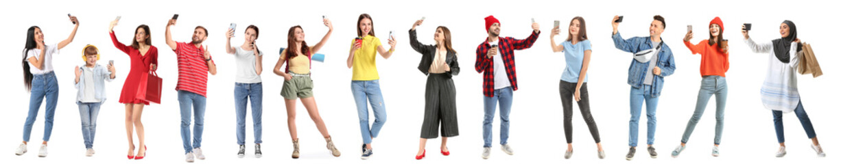 Beautiful young woman with mobile phone taking selfie on white background