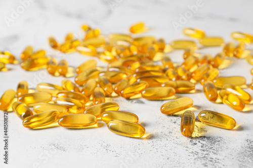 Fish oil pills on light background, closeup