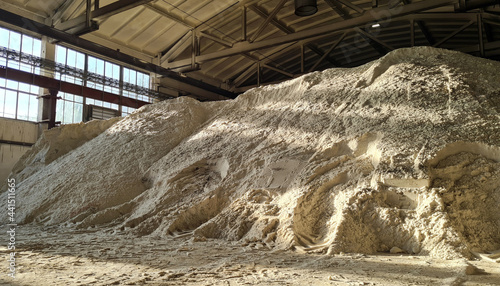 Pile of ammonium sulfate powder inside a warehouse of chemical plant. Mineral organic fertilizers for agriculture. photo