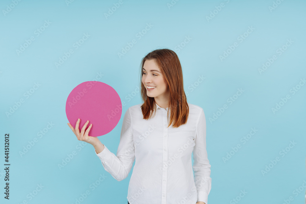 Pretty young woman holding up a blank round card or sign Pretty young woman holding up a blank round card or sign