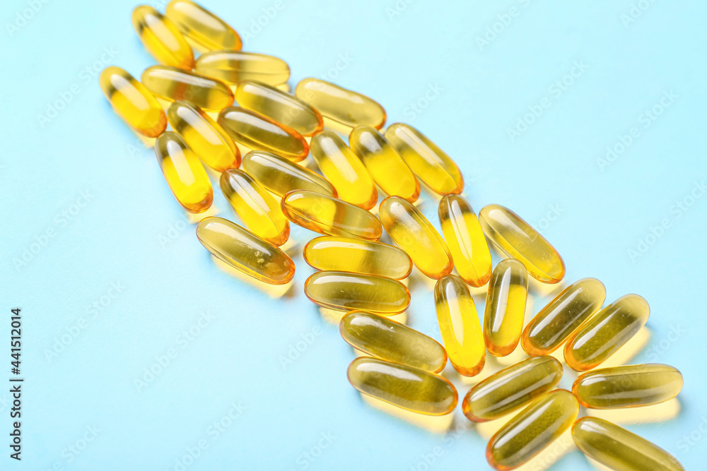 Fish oil capsules on color background Fish oil capsules on color background