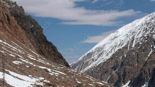 Timelaps of Severo-Chuisky mountain range and running clouds on blue sky. Altai Mountains, Russiia photo