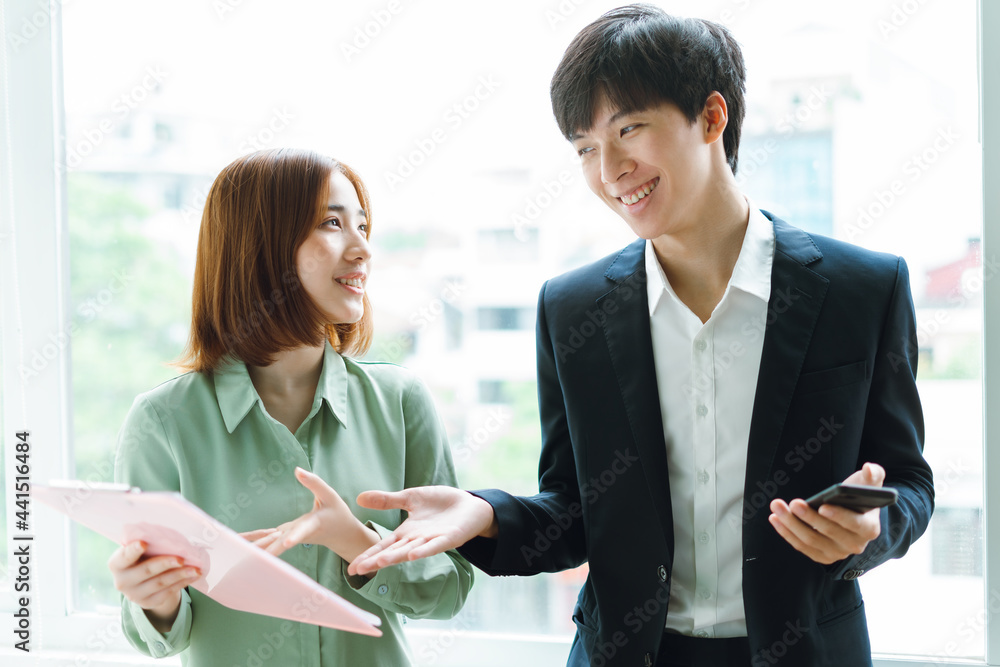 picture of boss and employee discussing work together picture of boss and employee discussing work together