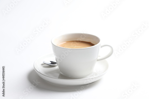 hot drink milk tea , milo , kopi coffee with milk in white cup and tea spoon and small plate in white background color beverage menu