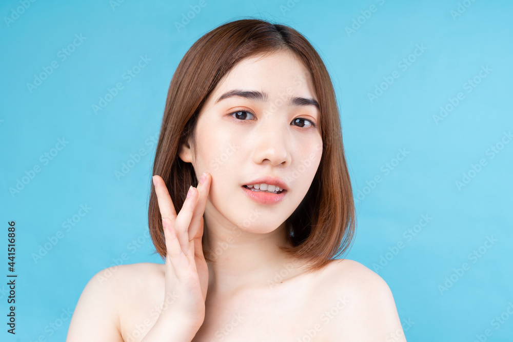 Attractive young Asian woman with youthful skin. Facial care, facial treatment, woman beauty skin isolated on white background. cosmetology, skin beauty and cosmetic concept Attractive young Asian woman with youthful skin. Facial care, facial treatment, woman beauty skin isolated on white background. cosmetology, skin beauty and cosmetic concept