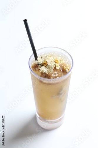 homemade cook ice cold chilled yellow Chrysanthemum flower tea in tall glass white background beverage menu