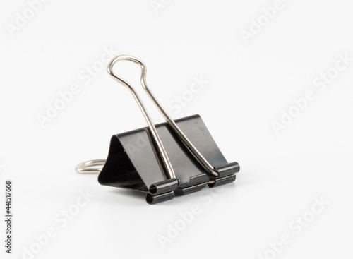 Black metal paperclips on white background