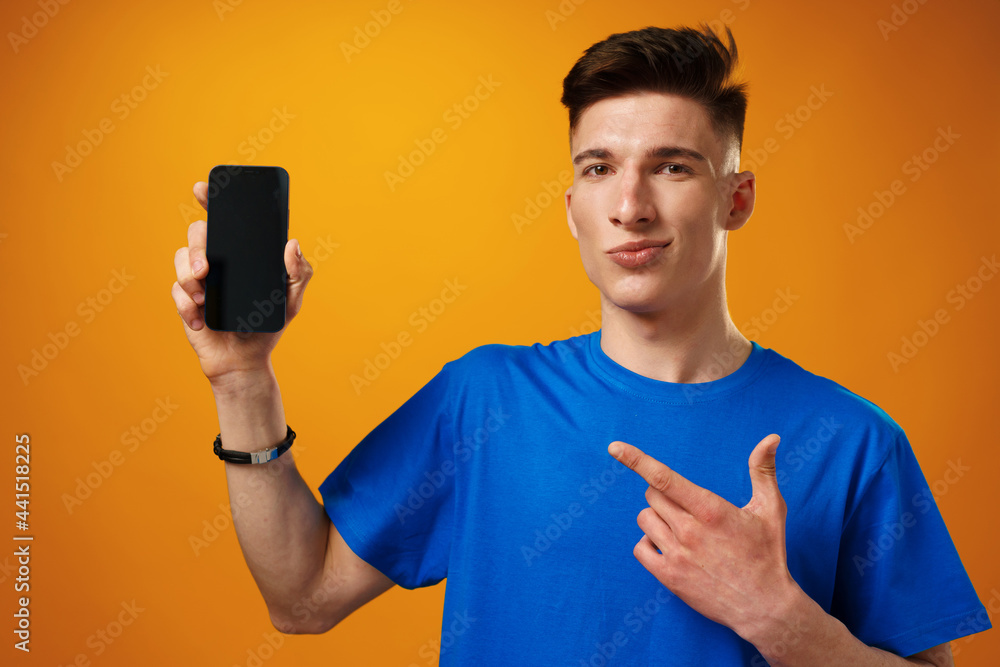 Young handsome man showing black smartphone screen Young handsome man showing black smartphone screen