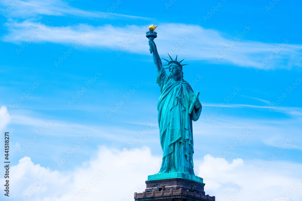 Fototapeta premium Statue of Liberty on the background with clouds and sky, Freedom concept,