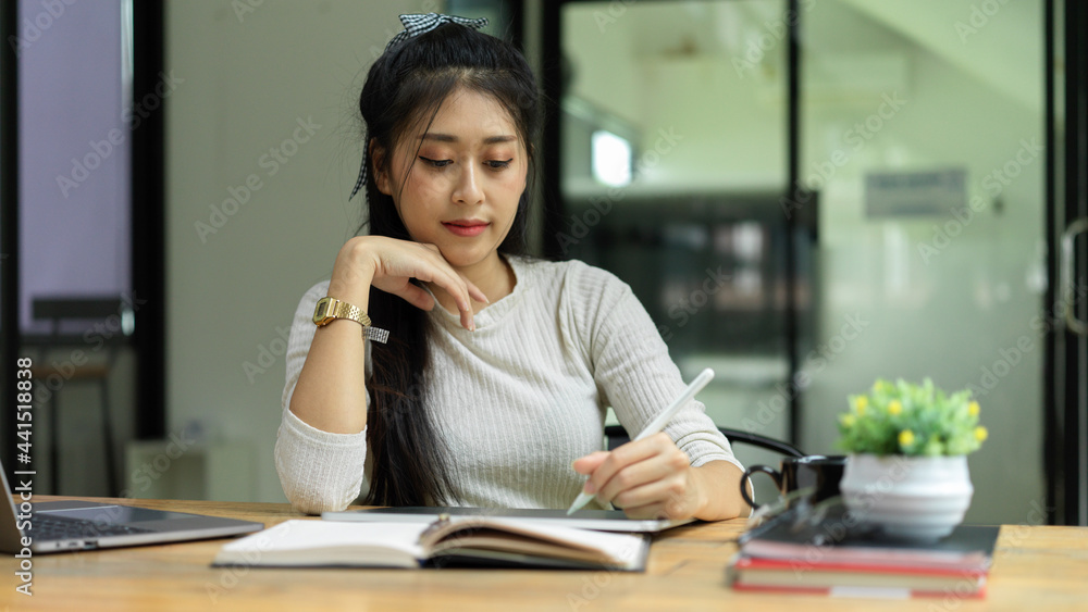 Portrait of female student reading book to prepare for upcoming exam at home Portrait of female student reading book to prepare for upcoming exam at home