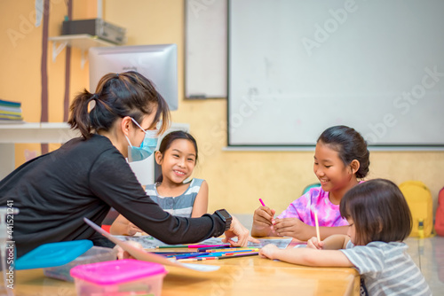 Education after coronavirus epidemic. Children, students are practicing drawing, practicing their coloring skills and having fun with each other. with a homeroom teacher to teach learning skills.