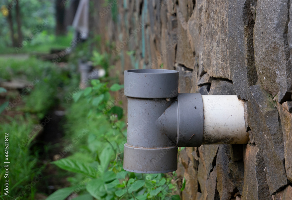 sewer pipe close-up with the stone embankment in the background sewer pipe close-up with the stone embankment in the background