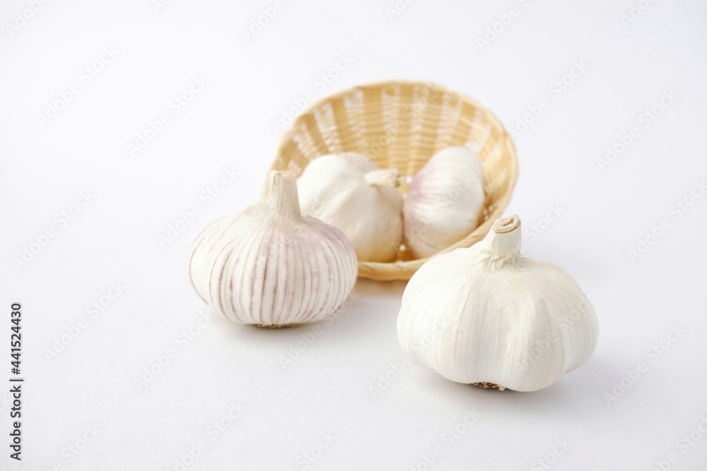 garlic on bamboo basket isolated on white background garlic on bamboo basket isolated on white background