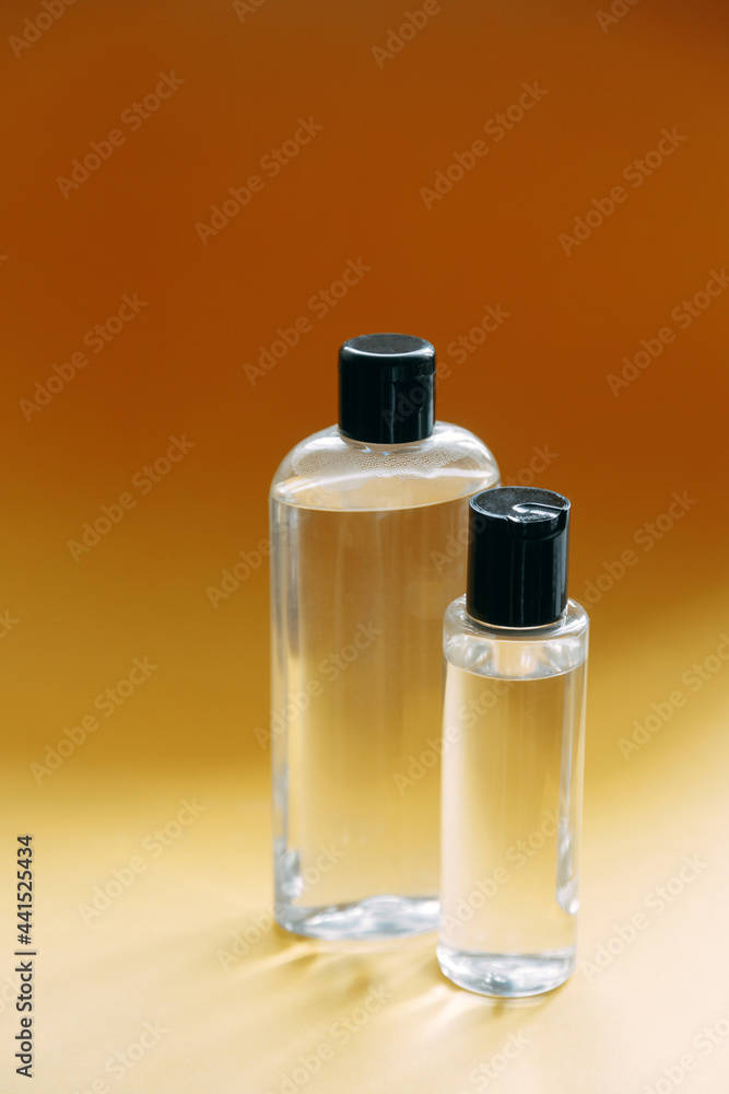 A set of eco-friendly natural cosmetics on a yellow background. Glass transparent bottles, a beautiful composition with an empty space for the text.