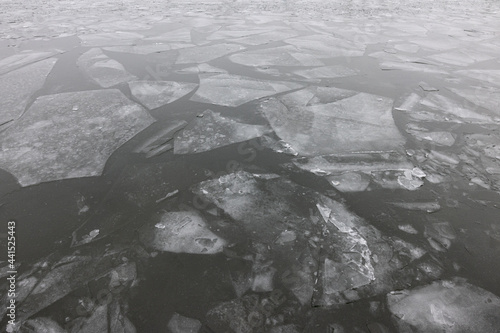 Broken large pieces of ice on a dark water of the Dnieper river